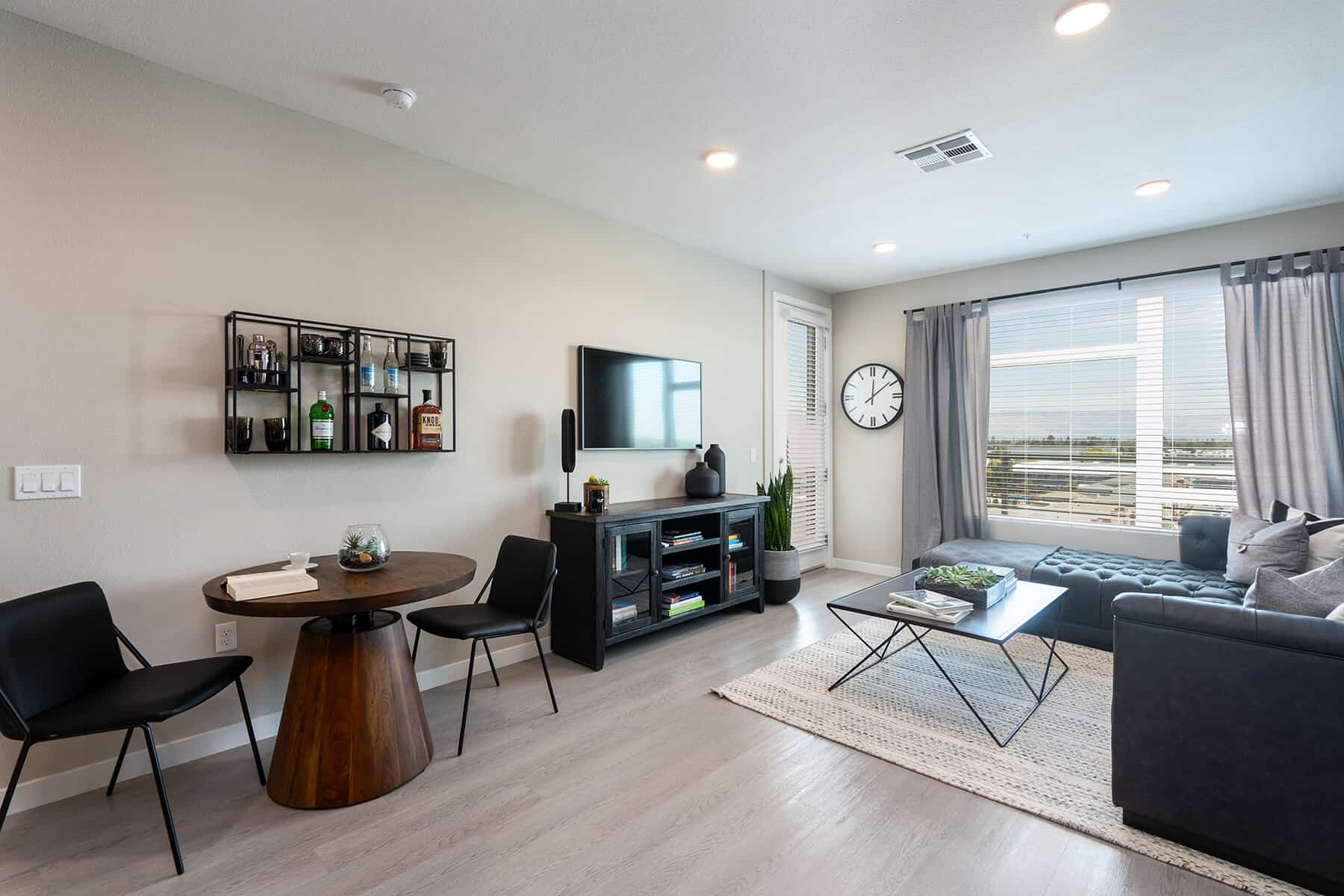 Pet-Friendly Apartments in Santa Clara CA - Prado-Sares-Regis - Spacious Living Room with Wood-Style Flooring, Large Window, and Access to Private Patio